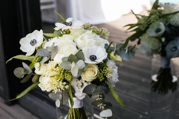 A wedding bouquet of white flowers of peony, roses, eucalyptus stands in a vase. Wedding concept 