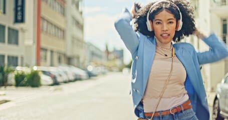 Obraz premium Music, street and black woman dance with energy, wellness and freedom while streaming rap, hip hop or radio sound. Headphones, crazy fun and retro dancer listening to audio song while dancing in city