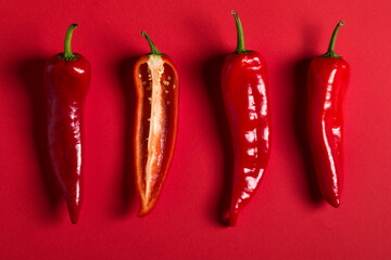 Red pepper on the red background.