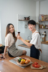 Young adorable Asian partner celebrate togehter in kitchen.