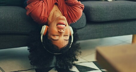 Headphones, listening and dance of black woman on a sofa excited for subscription service,...