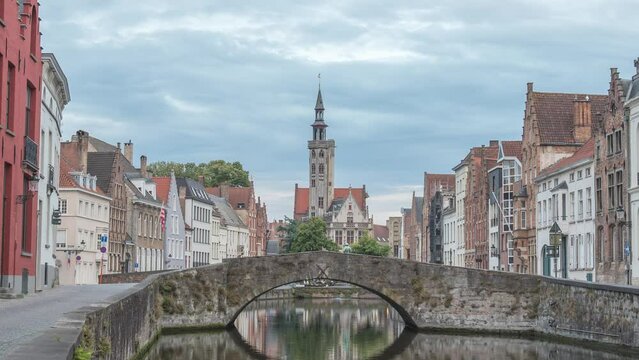 Bruges Belgium time lapse 4K, city skyline day to night timelapse at Spiegelrei Canal with King's Bridge (Koningsbrug)