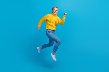 Fototapeta na wymiar Full body length photo of hurry running air blonde hair lady wear stylish autumn outfit addicted shopaholic isolated on blue color background