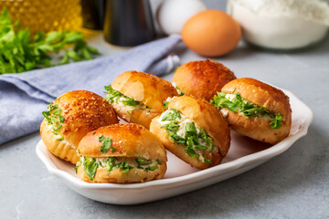 Turkish pastry filled with dill, parsley, cream cheese and cheddar cheese. Turkish name: Sakallı Pogaca or Saçaklı Pogaca