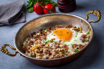 From traditional Turkish cuisine; fried eggs with meat. Turkish name; kavurmali yumurta