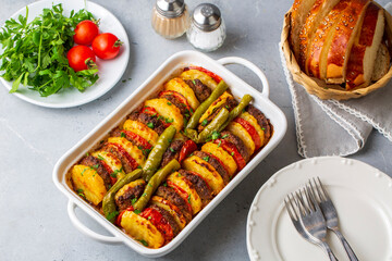 Traditional Turkish food; baked potatoes and meatballs. Turkish name; kofteli patates dizmesi, patates dizme