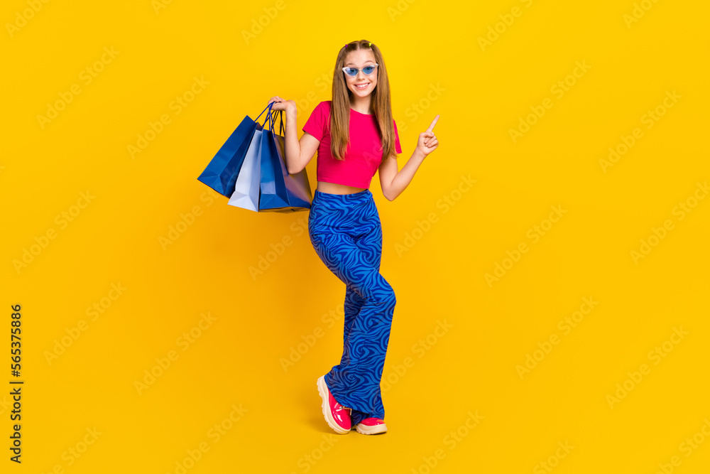 Sticker Photo of cute lovely stylish lady wear trendy outfit presenting empty space collection clothes isolated on yellow color background