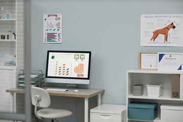 Workplace of vet expert with information on screen of computer monitor
