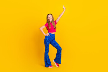 Photo of cheerful lovely lady wear trendy clothes have fun good mood stand near empty space isolated on yellow color background