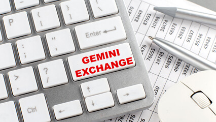 GEMINI EXCHANGE text on a keyboard wirh chart and pencil