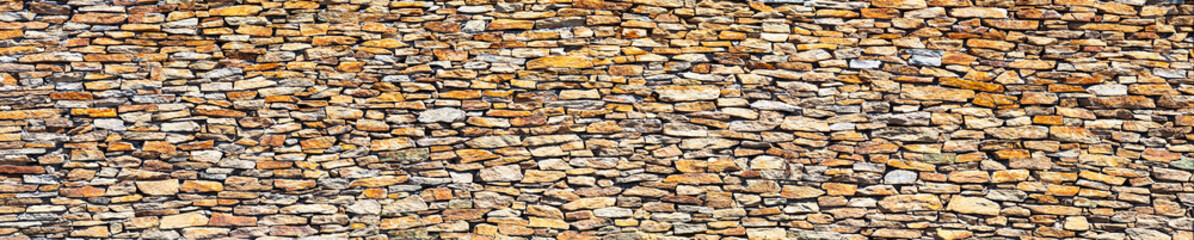 Slate stone wall, panorama. Abstract natural background or texture.