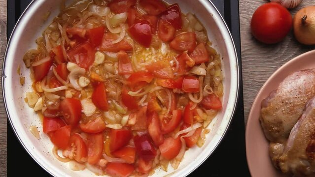 Red spicy sauce with vegetables tomatoes onions carrots
