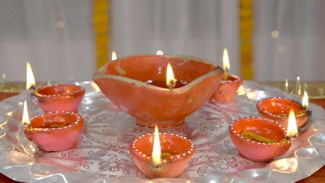 Burning Diyas or earthen lamps decorated in a Thali