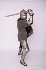 Romantic knight in armor with sword and helmet. Warrior in chain mail on a white background.