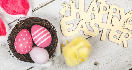 Fototapeta na wymiar greeting card with text happy easter. multicolored easter eggs on wooden background