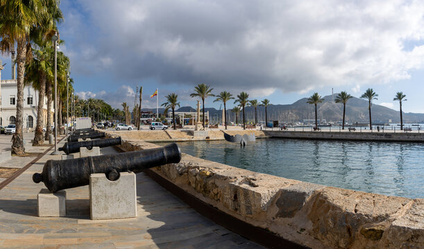 Historic Canons at the harbour of Cartagena, Spain near the Whale tail sculpture and palm trees in the background