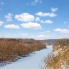 frozen river among prairie at winter day