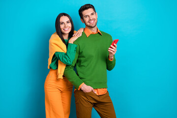 Photo of positive spouses guy lady use modern device enjoy social network blogging isolated blue color background