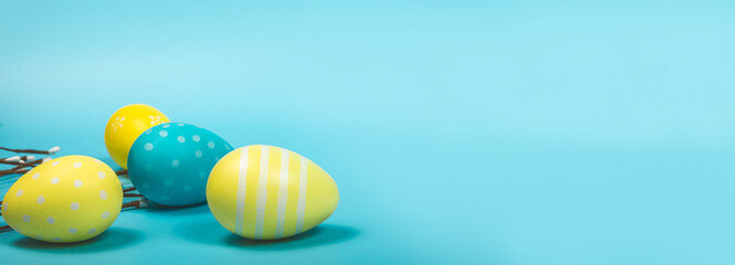 Happy easter banner. Yellow Easter eggs on a pastel blue background