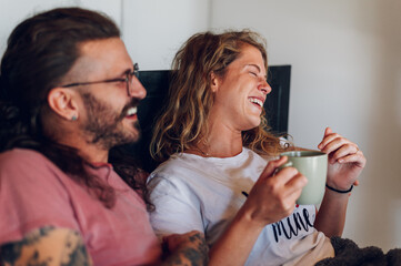 Romantic couple lying in the bed at home in the morning