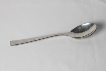 Silver spoon on white background