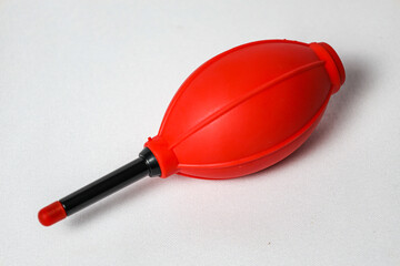 Red Rubber Blower on White Background. Close-up Image