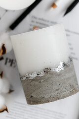 Handmade wax and concrete candle with gilding on journal. Holiday Advent. Cozy atmosphere. 