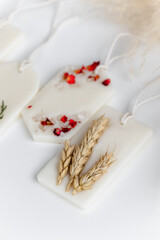 Aroma sachet with dried flowers with coconut or organic soy wax. Close up on white background