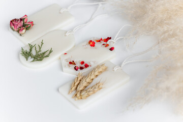 Obraz na płótnie Canvas Aroma sachet with dried flowers with coconut or organic soy wax. Close up on white background