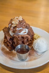 Chocolate waffle with ice cream served on plate