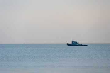 dusk sky in summer vacation skyscape with ship on horizon