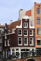 Fototapeta premium Amsterdam Singel Canal House Facade with Bridge and Bicycles, Netherlands