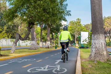 unidentified person riding a bicycle in a bike path