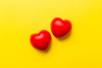 red heart shape on colored background. minimal concept top view with copy space