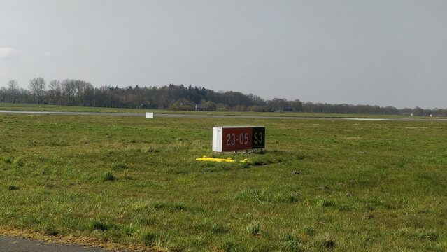 Airport sign at holding point Sierra 3 next to runway 05 at Groningen Airport in Eelde
