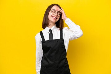 Young Ukrainian waitress woman isolated on yellow background smiling a lot