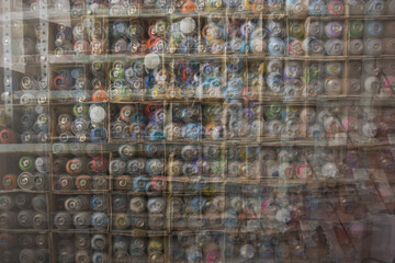 Multiple exposure photo of spraycans on a shelf, background pattern-texture