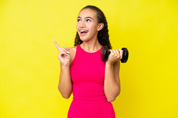 Young sport woman making weightlifting isolated on yellow background intending to realizes the solution while lifting a finger up