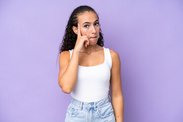 Young woman isolated on purple background thinking an idea