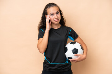 Young football player woman isolated on beige background thinking an idea