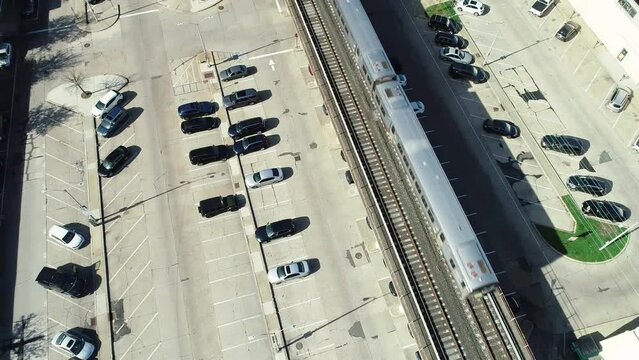Drone overhead Long Island Railroad train passing by Rockville Centre on Long Island, NY.