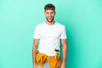 Young electrician blonde man isolated on green background with surprise facial expression