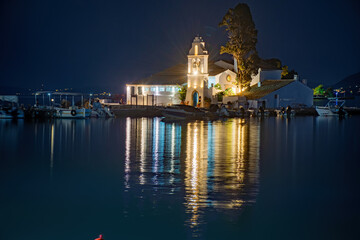KANONI, CORFU, GREECE - September 19, 2021:Illuminated night scene of Vlacherna monastery and Pontikonisi island, Kanoni, Corfu