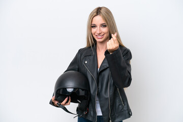 Pretty blonde woman with a motorcycle helmet isolated on white background making money gesture