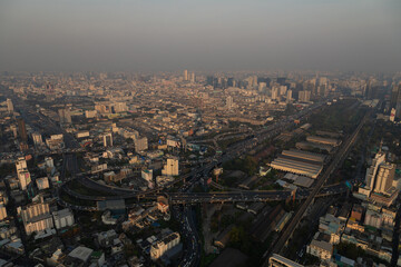 Fototapeta na wymiar Panoramic view of Bangkok, its districts, neighborhoods and streets, crisscrossed by highways full of traffic and vehicles