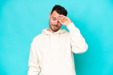 Young caucasian handsome man isolated on blue background with tired and sick expression