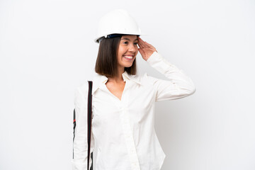 Young architect woman with helmet and holding blueprints isolated on white background smiling a lot