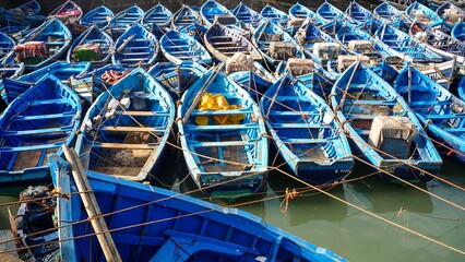 Fototapeta na wymiar Traditional blue boats in a harbour in Marocco