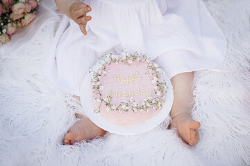 Baby birthday cake and newborn feet, toes, very pretty and sweet. First birthday smash the cake.