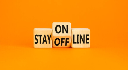 Stay online or offline symbol. Concept word Stay online or offline on wooden cubes. Beautiful orange table orange background. Business and stay online or offline concept. Copy space.